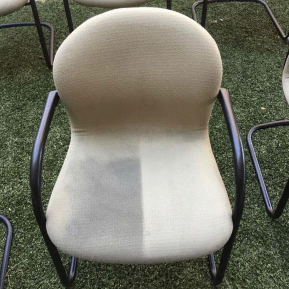 Clean vs. dirty office chair on grass, highlighting upholstery restoration before and after.