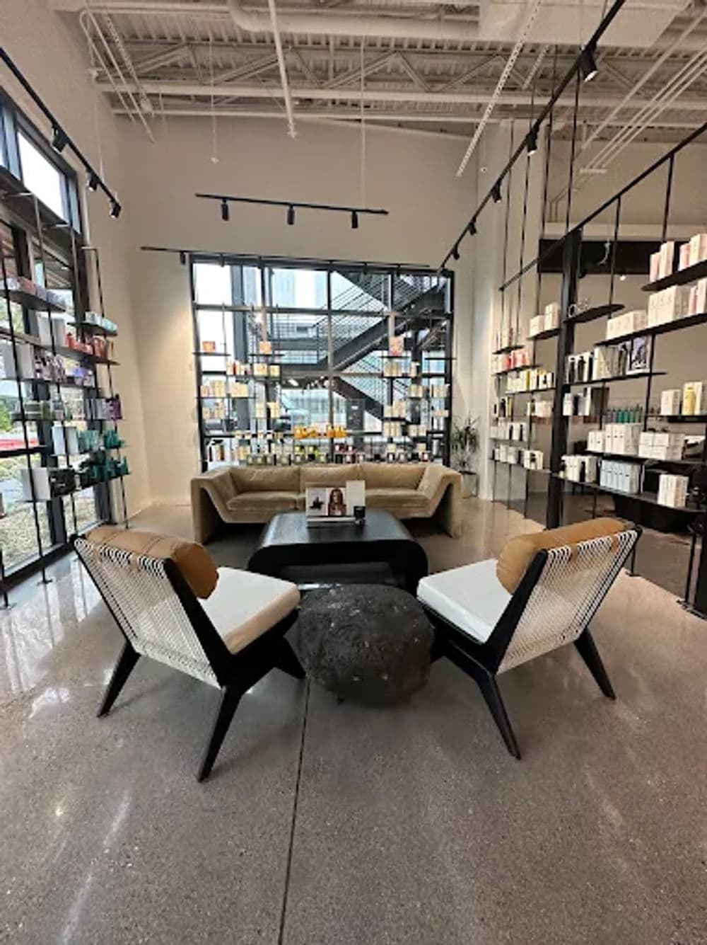 Modern interior of a beauty store featuring stylish seating and product displays.